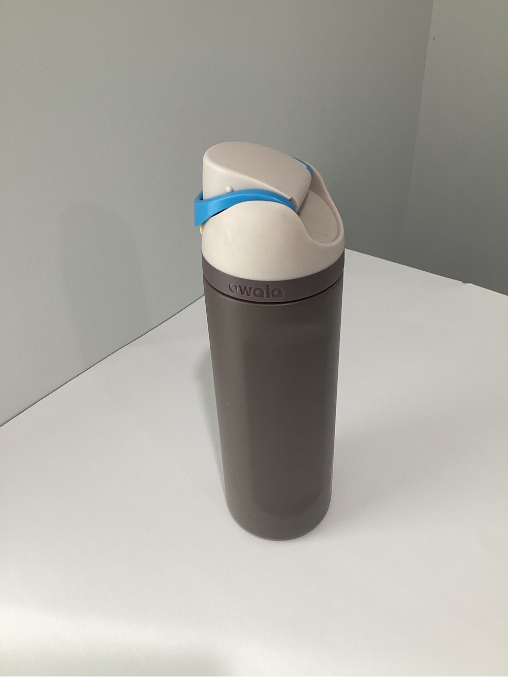 Owala Insulated Bottle in Taupe with Cream Lid and Blue Strap